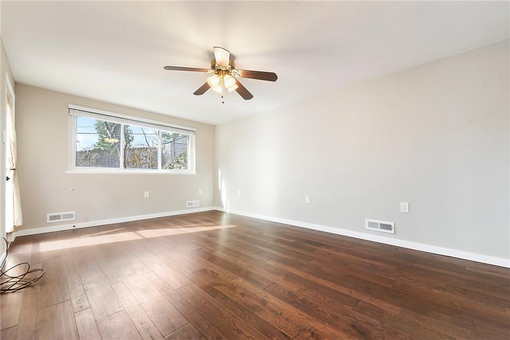 6913 Merton Road Pittsburgh, PA 15202 - Photo 26 of 48 a view of an empty room with wooden floor and a window