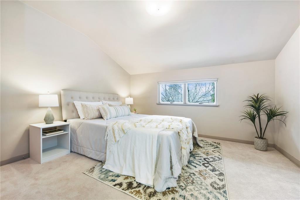 6913 Merton Road Pittsburgh, PA 15202 - Photo 29 of 48 a bedroom with a large bed and a potted plant