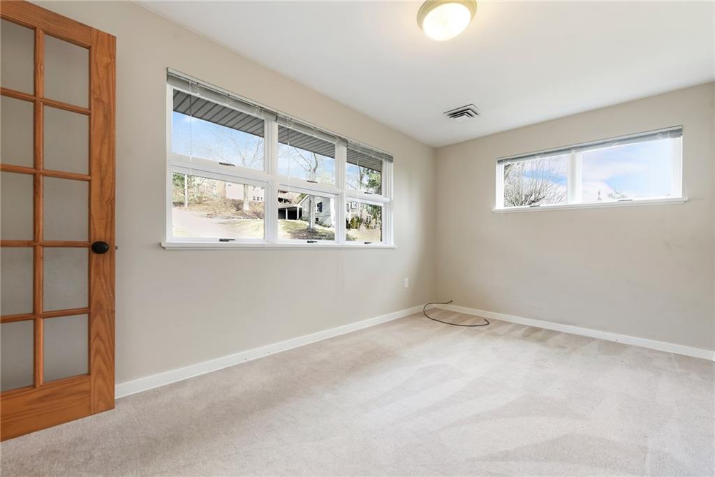 6913 Merton Road Pittsburgh, PA 15202 - Photo 32 of 48 an empty room with wooden floor and windows
