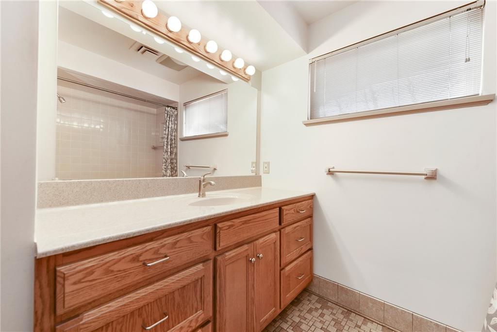 6913 Merton Road Pittsburgh, PA 15202 - Photo 38 of 48 a bathroom with a sink a vanity and mirror
