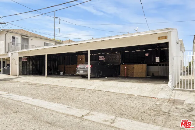 a front view of a building with a window and a garage