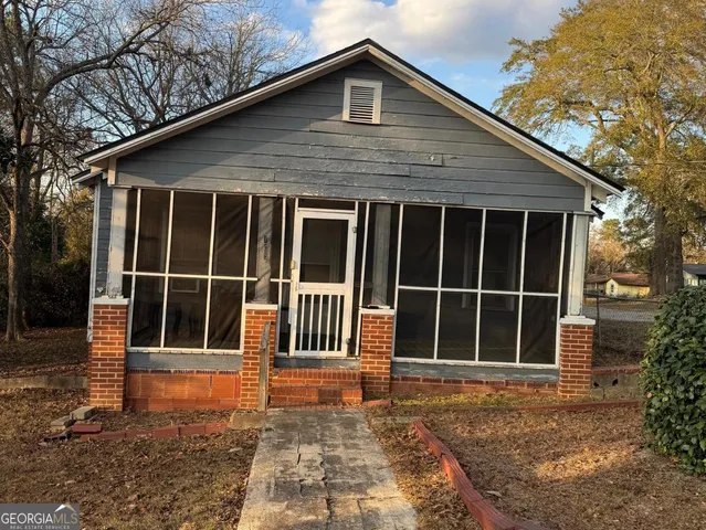 a house with trees in the background