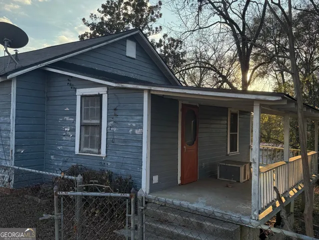 a front view of a house with yard and seating area