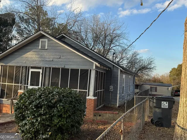 a view of a house with street and trees