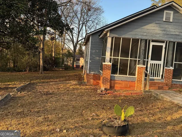 a backyard of a house with table and chairs