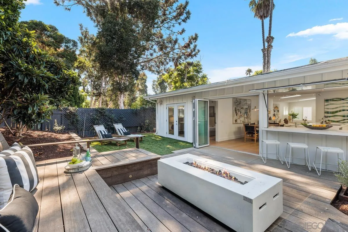 a view of a house with couches chairs and wooden floor