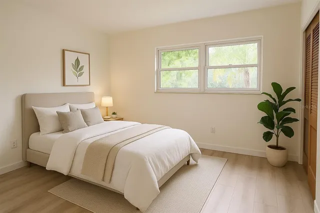 a bedroom with a bed and a window