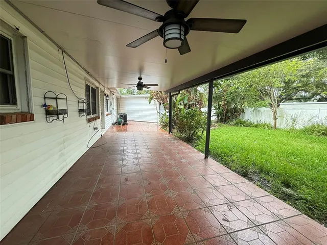 a view of a porch with chairs and backyard