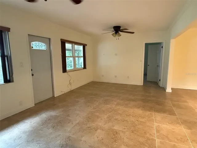 an empty room with windows and closet