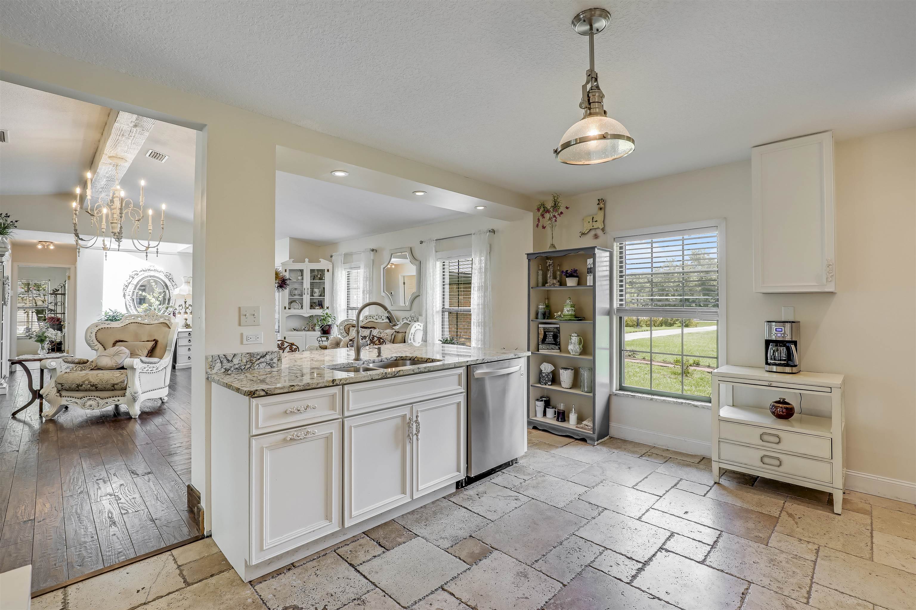 4485 Highway 16 St. Augustine, FL 32092 - Photo 21 of 59 a kitchen with stainless steel appliances kitchen island granite countertop a sink and cabinets