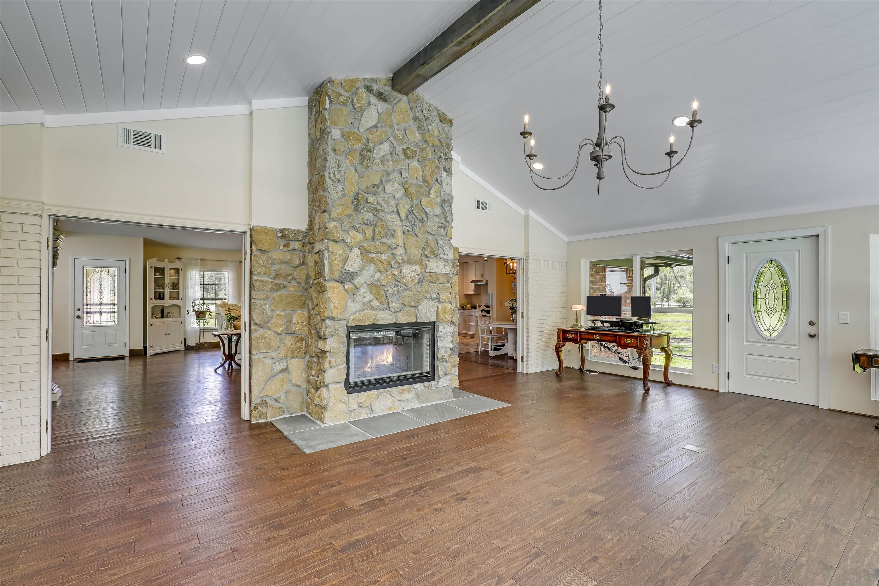 4485 Highway 16 St. Augustine, FL 32092 - Photo 28 of 59 an empty room with fireplace wooden floor and windows