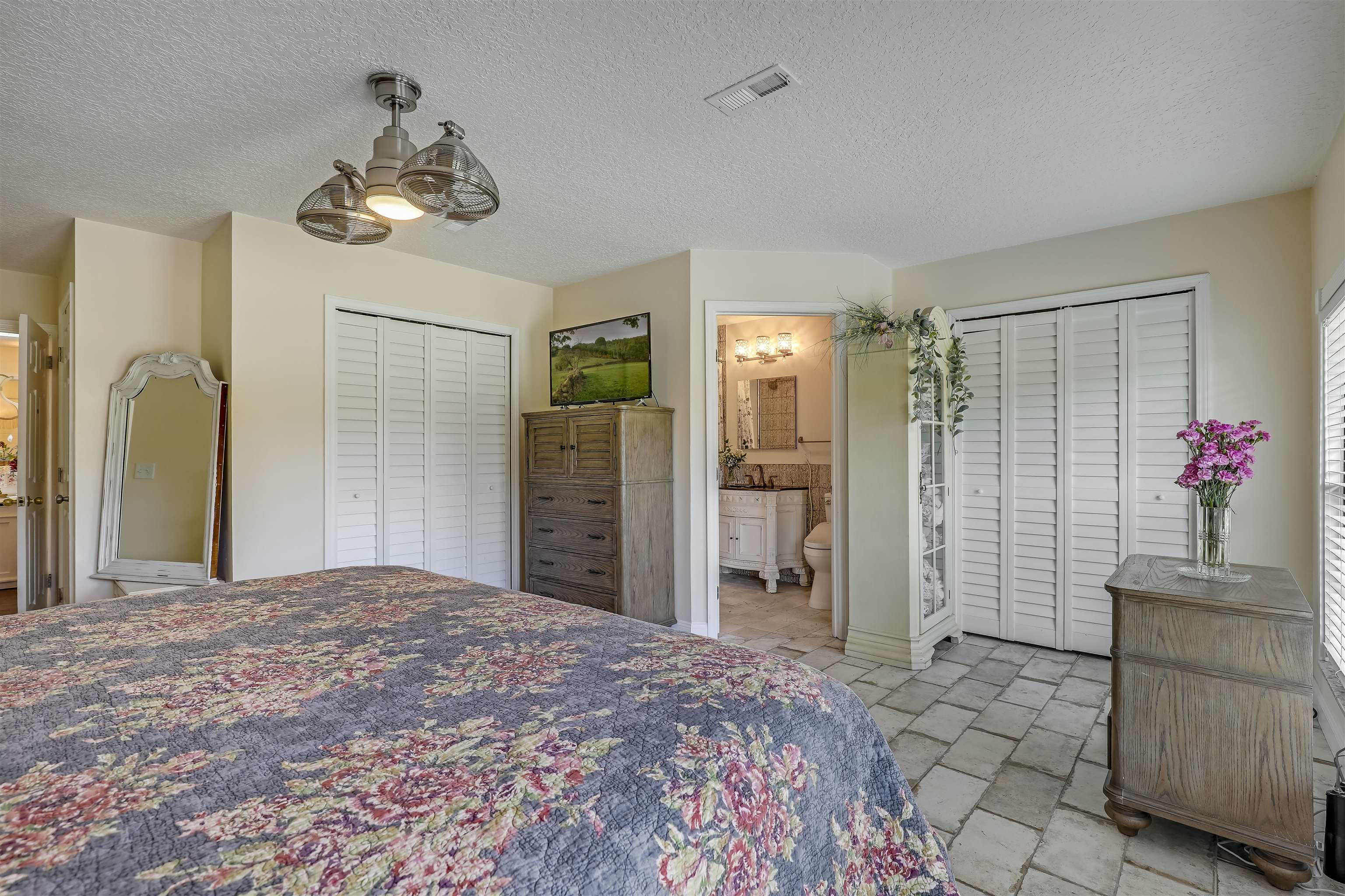 4485 Highway 16 St. Augustine, FL 32092 - Photo 30 of 59 a bedroom with a bed and a chandelier