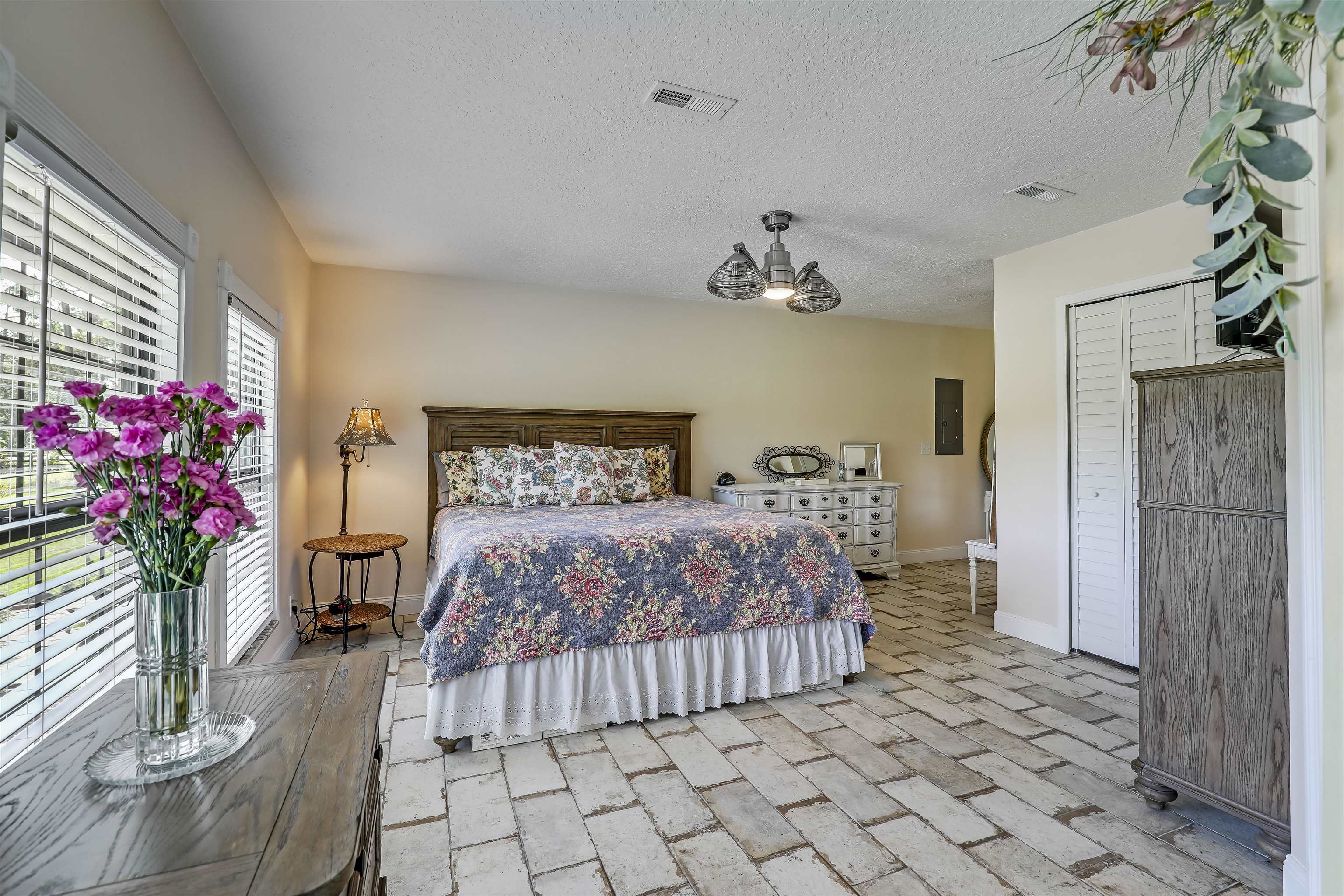 4485 Highway 16 St. Augustine, FL 32092 - Photo 31 of 59 a bedroom with a bed and a chandelier