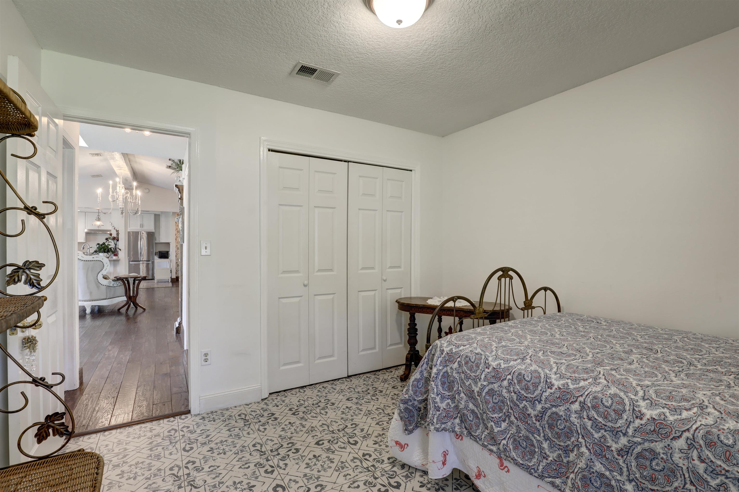 4485 Highway 16 St. Augustine, FL 32092 - Photo 40 of 59 a bedroom with a bed and a dresser with mirror