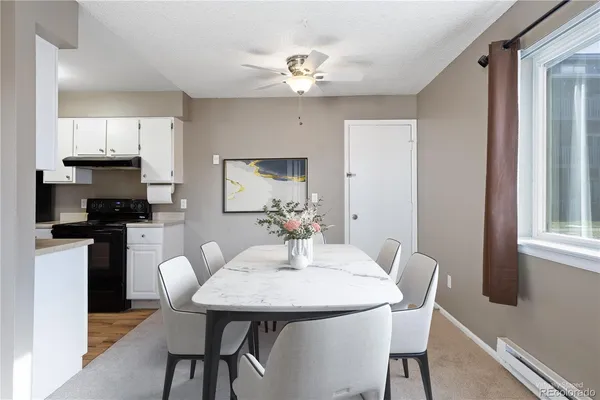 a view of a dining room with furniture and wooden floor
