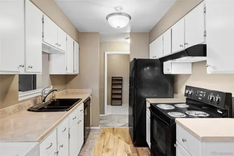 a kitchen with a sink stove and refrigerator