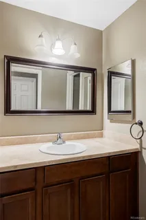 a bathroom with a sink vanity and a mirror