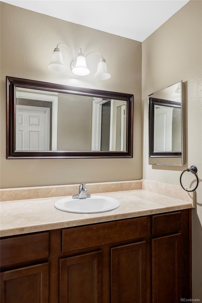 8100 West Quincy Avenue, Unit K3 Littleton, CO 80123 - Photo 11 of 19 a bathroom with a sink vanity and a mirror