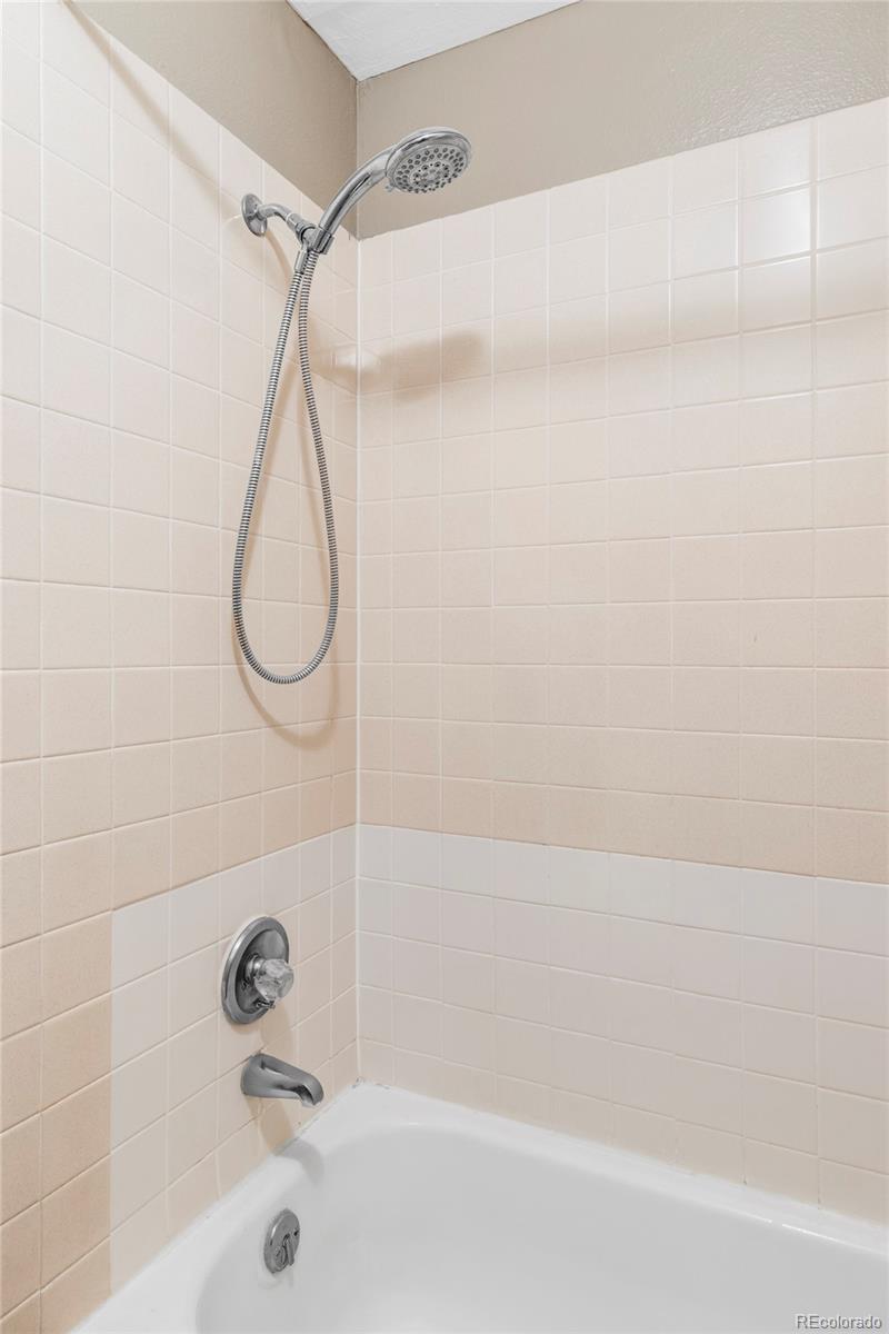 8100 West Quincy Avenue, Unit K3 Littleton, CO 80123 - Photo 12 of 19 a bathroom with a bath tub with a shower