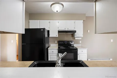 a kitchen with stainless steel appliances a refrigerator and a stove