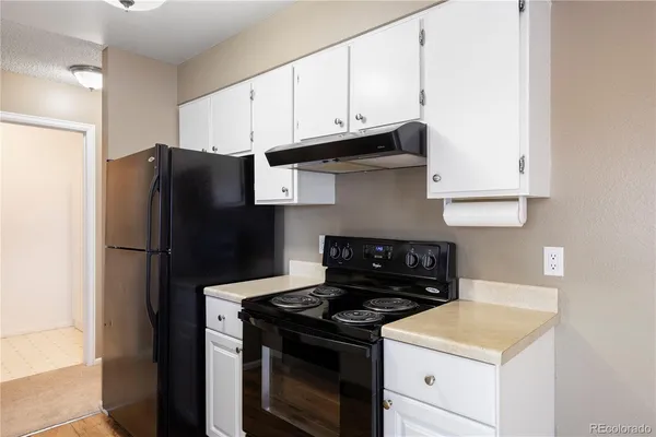 a kitchen with a stove and a refrigerator