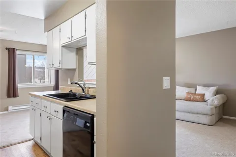a kitchen with stainless steel appliances granite countertop a sink and a stove