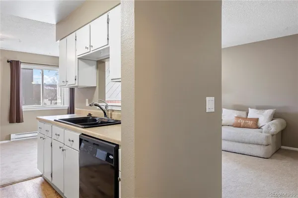 a kitchen with stainless steel appliances granite countertop a sink and a stove