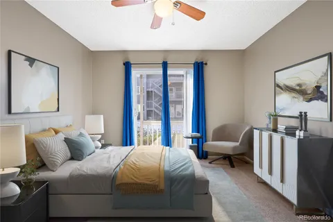 a bedroom with a bed couch and a window