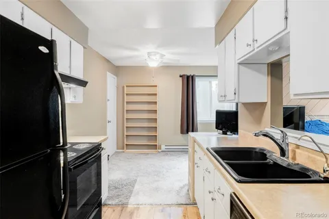 a kitchen with a refrigerator sink and stove