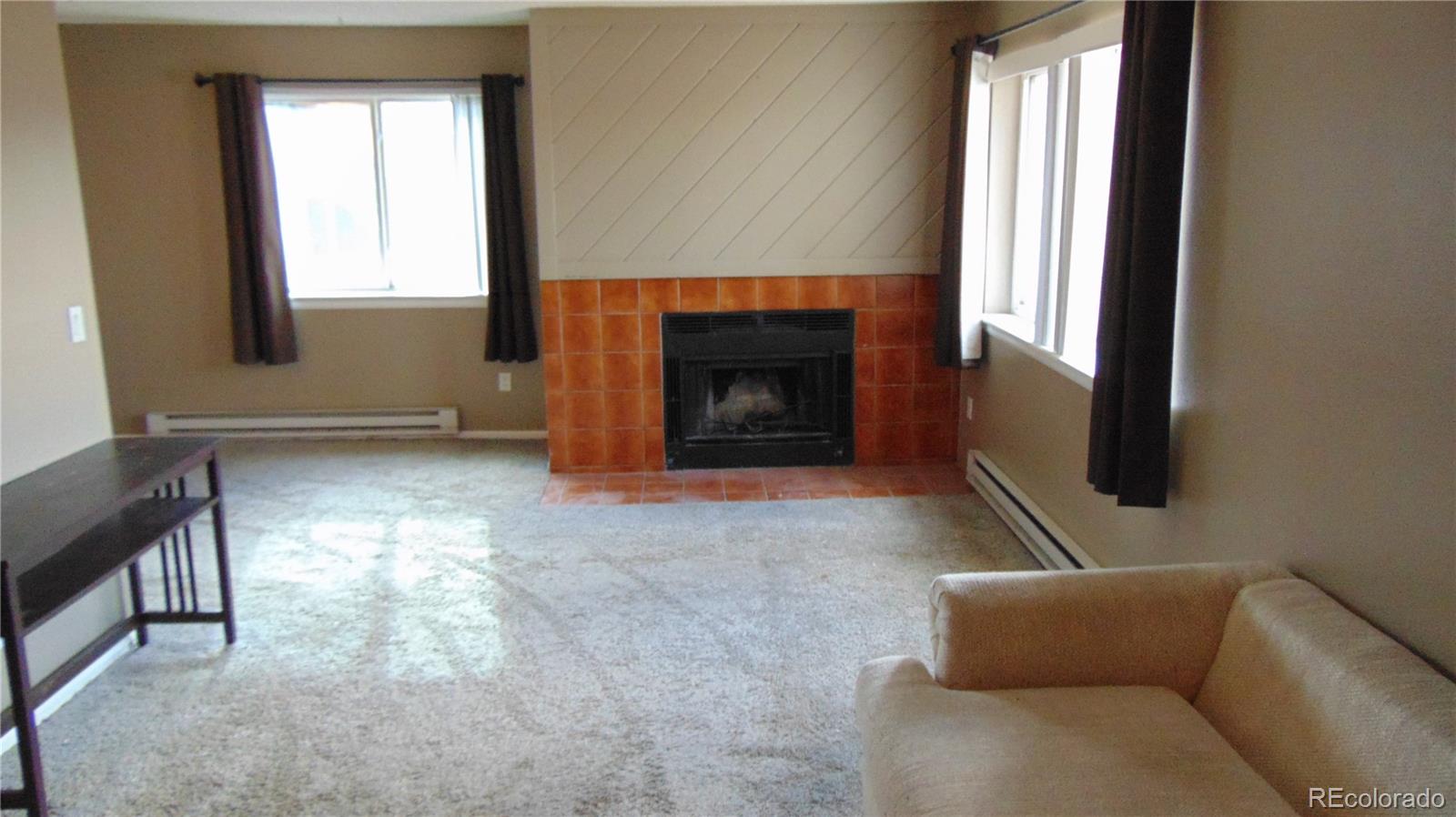 8100 West Quincy Avenue, Unit K3 Littleton, CO 80123 - Photo 7 of 19 a living room with furniture and a fireplace
