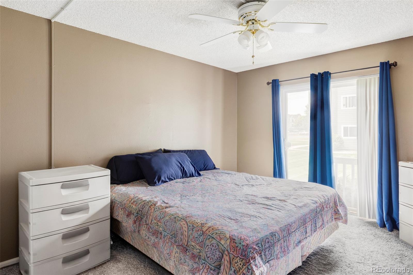 8100 West Quincy Avenue, Unit K3 Littleton, CO 80123 - Photo 10 of 19 a bedroom with a bed and a chandelier