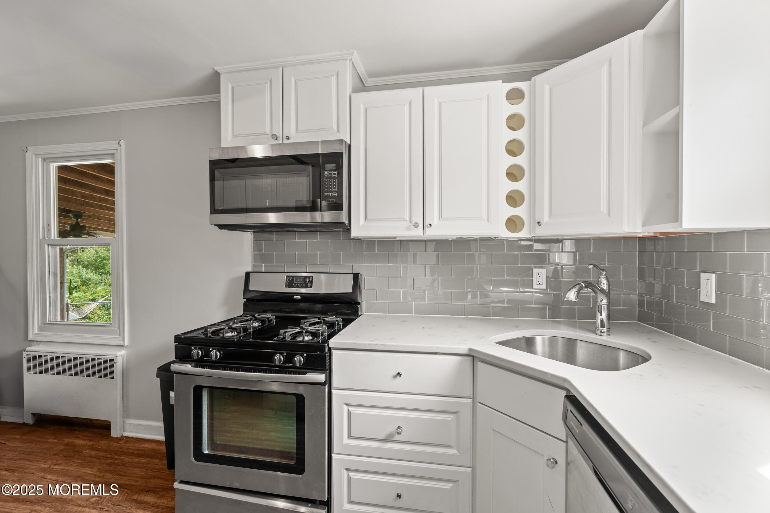324 Cedar Avenue Elberon, NJ 07740 - Photo 12 of 25 a kitchen with cabinets stainless steel appliances a sink and a stove