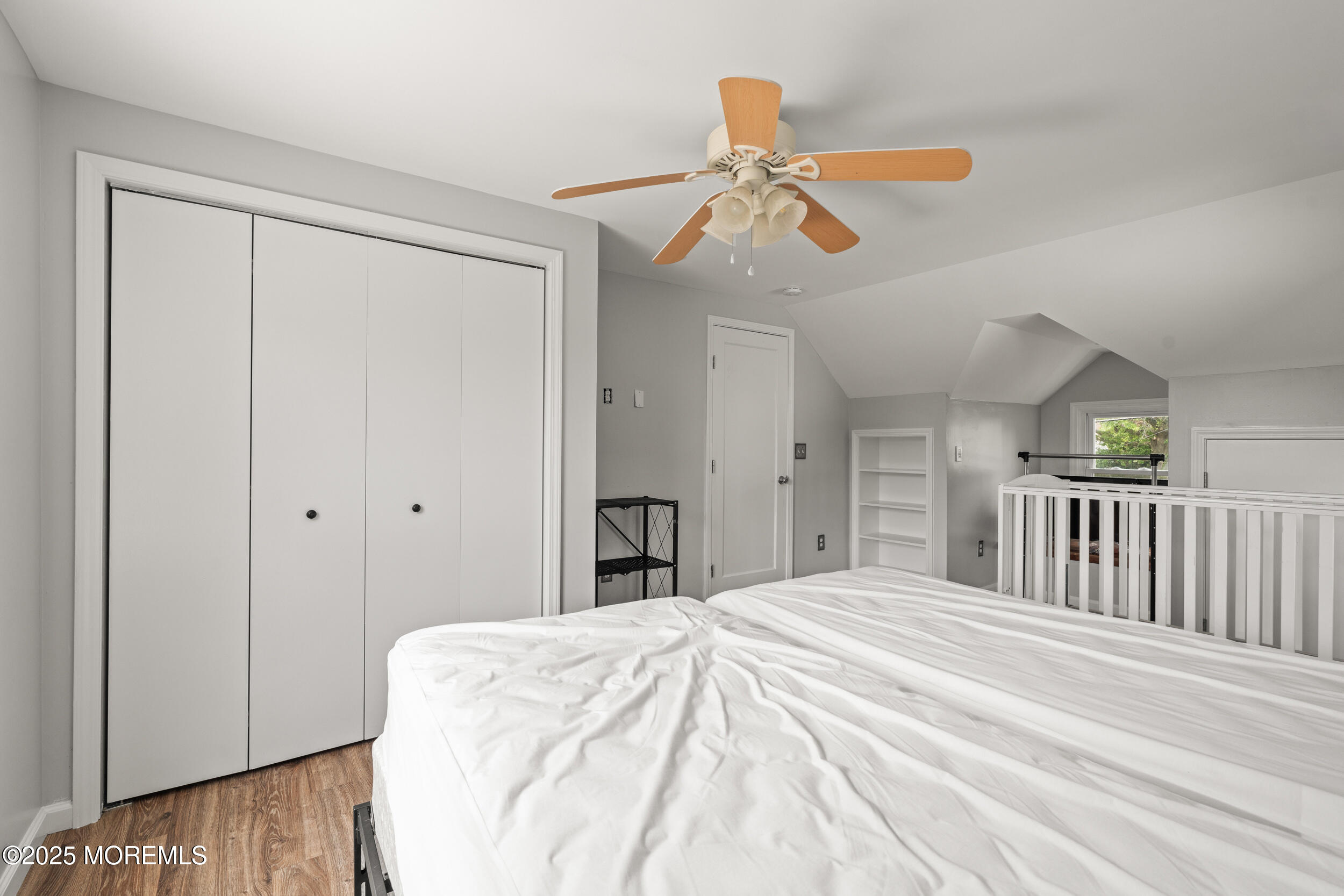 324 Cedar Avenue Elberon, NJ 07740 - Photo 22 of 25 a bedroom with a bed and a chandelier