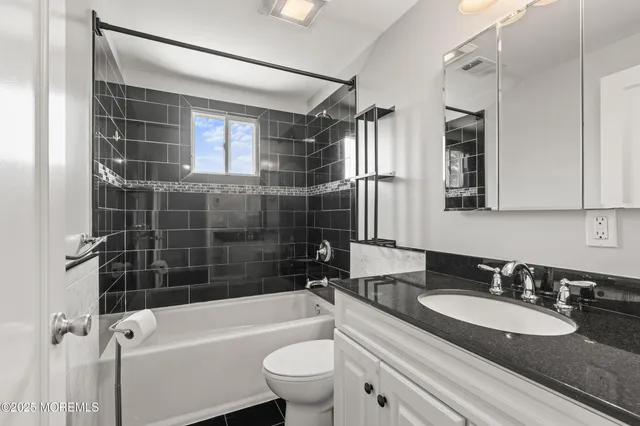 a bathroom with a sink a toilet and bathtub