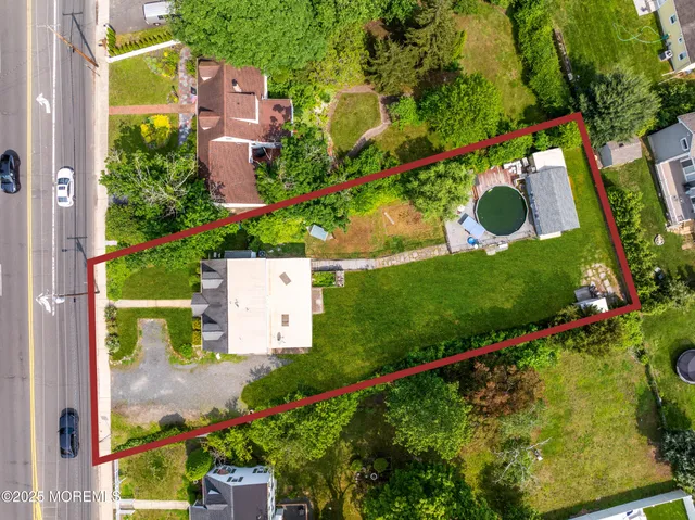 an aerial view of residential house with outdoor space and street view