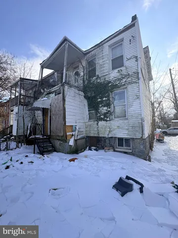 a view of a house with a snow in the yard