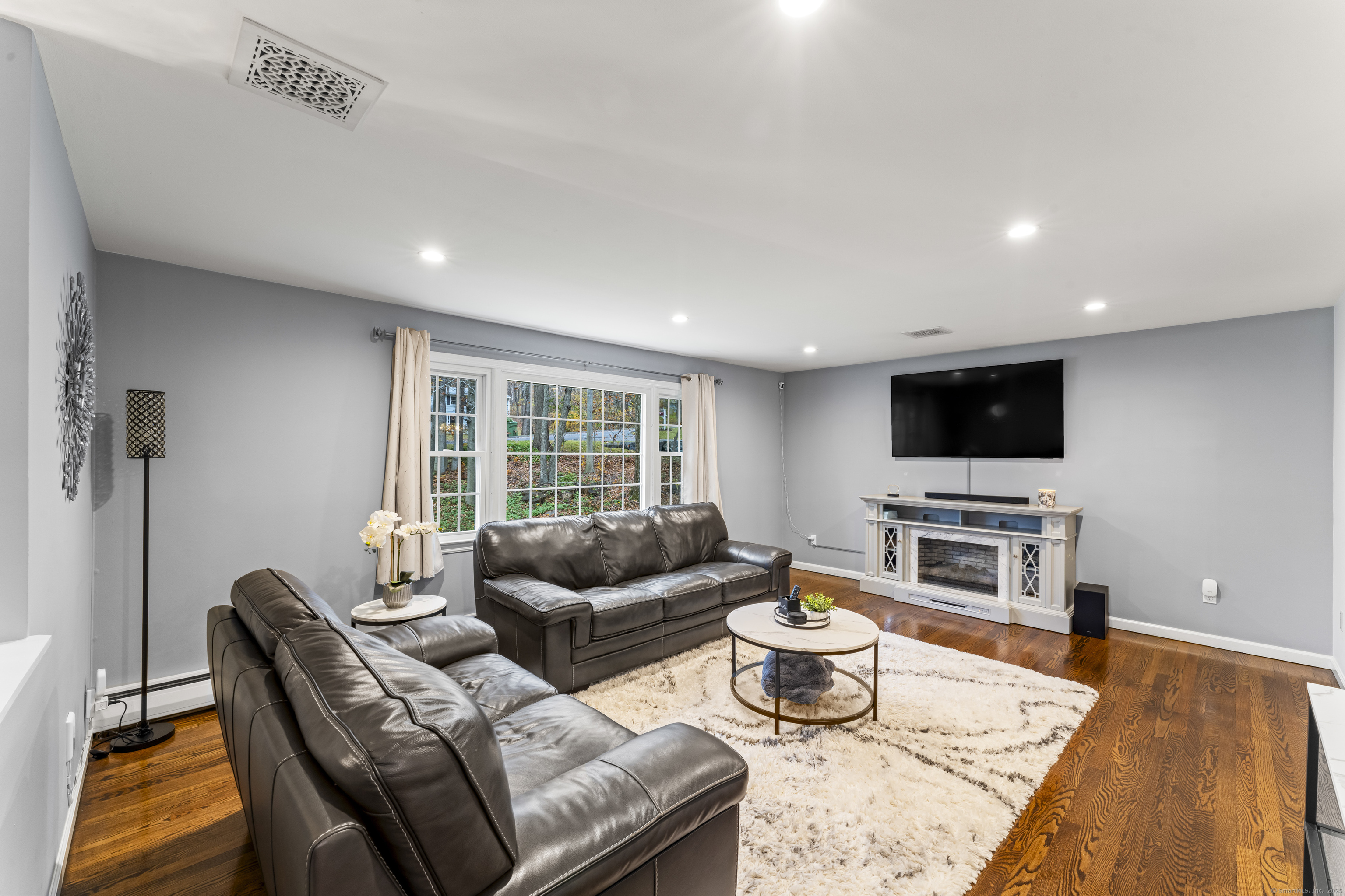 8 Possum Ridge Road Newtown, CT 06470 - Photo 11 of 38 a living room with furniture and a flat screen tv