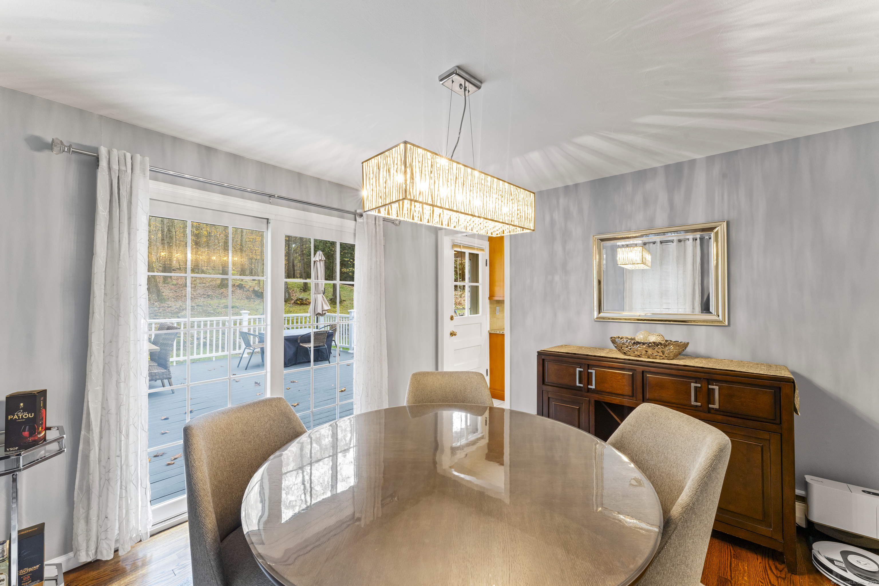 8 Possum Ridge Road Newtown, CT 06470 - Photo 12 of 38 a dining room with furniture a chandelier and wooden floor