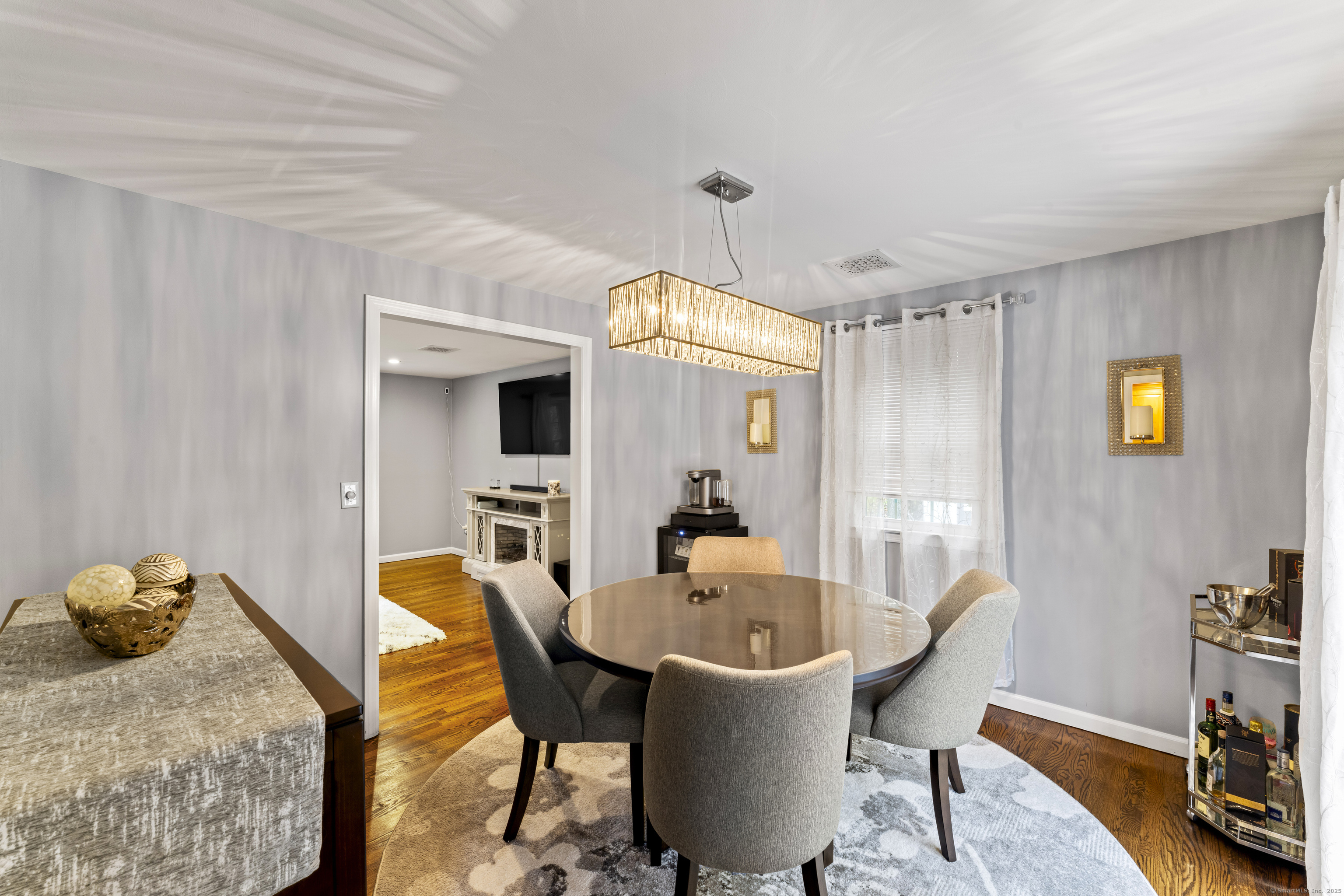 8 Possum Ridge Road Newtown, CT 06470 - Photo 14 of 38 a view of a dining room with furniture and a chandelier