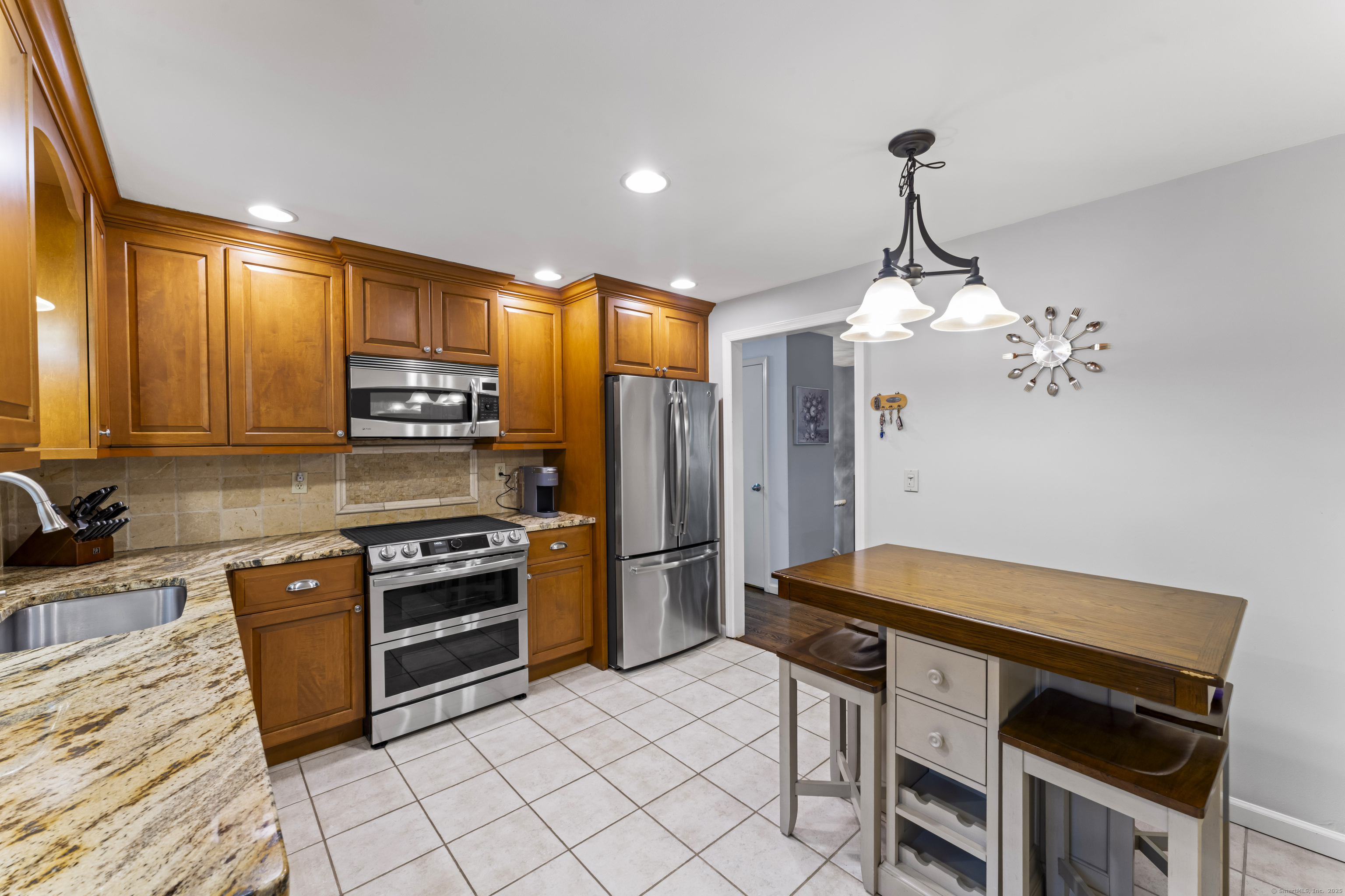 8 Possum Ridge Road Newtown, CT 06470 - Photo 15 of 38 a kitchen with stainless steel appliances a stove a refrigerator and cabinets