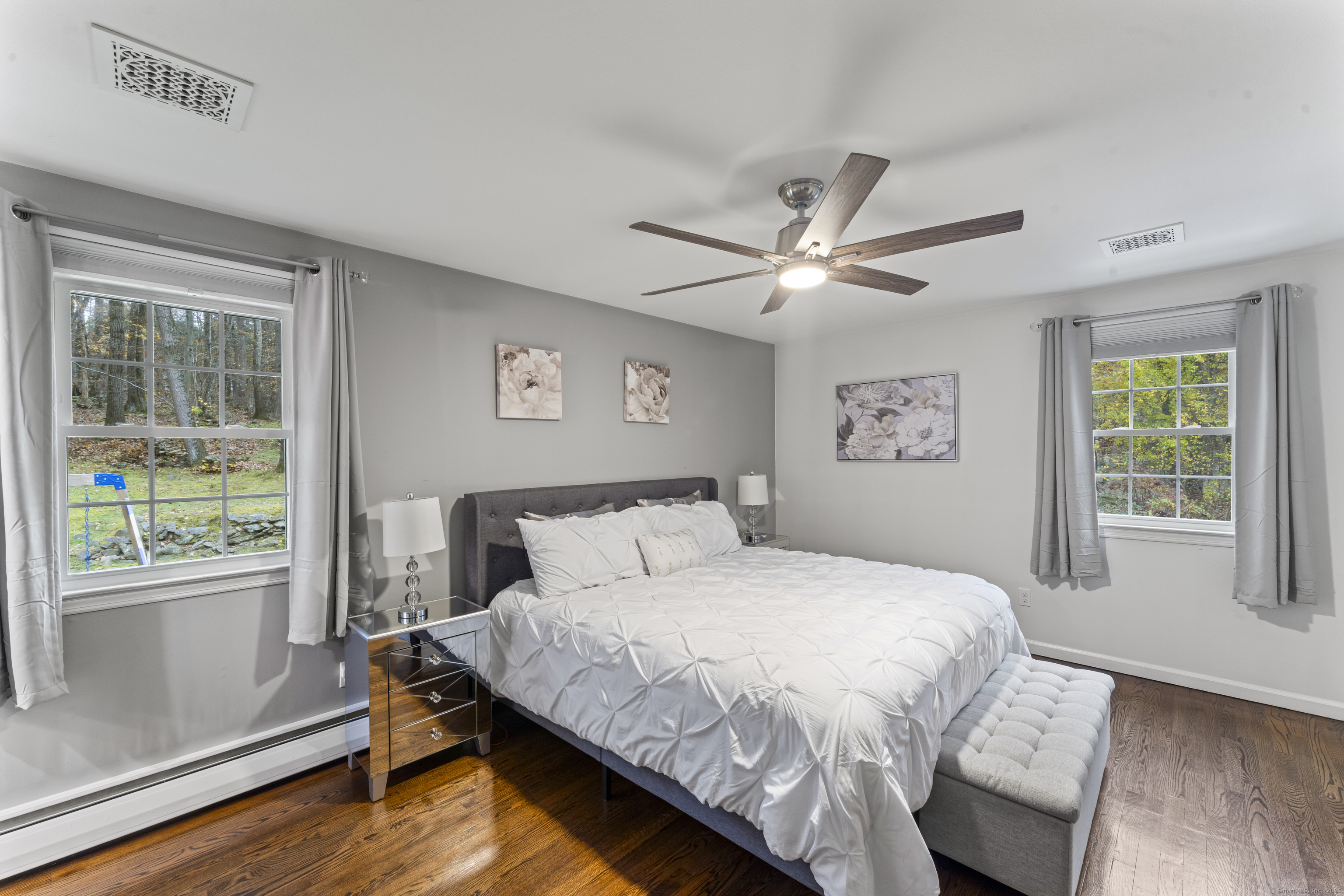 8 Possum Ridge Road Newtown, CT 06470 - Photo 21 of 38 a bedroom with a large bed chandelier and a window
