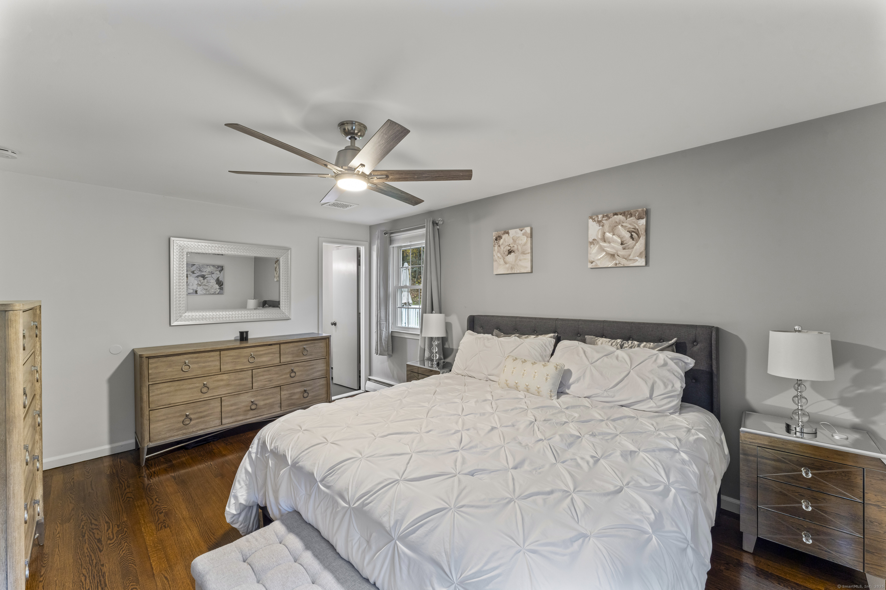 8 Possum Ridge Road Newtown, CT 06470 - Photo 22 of 38 a bedroom with a large bed and a chandelier