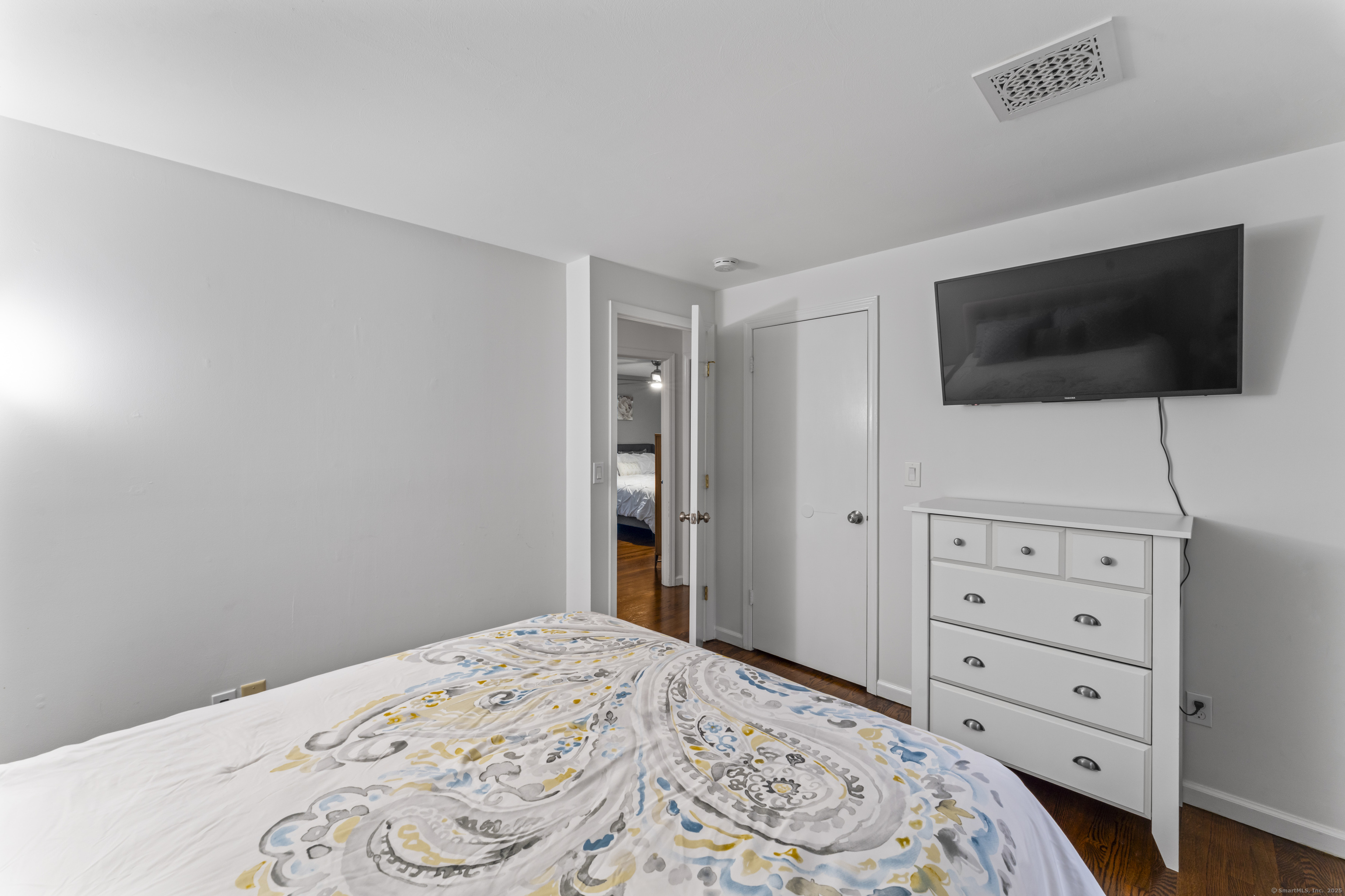 8 Possum Ridge Road Newtown, CT 06470 - Photo 32 of 38 a bedroom with a bed and a flat screen tv