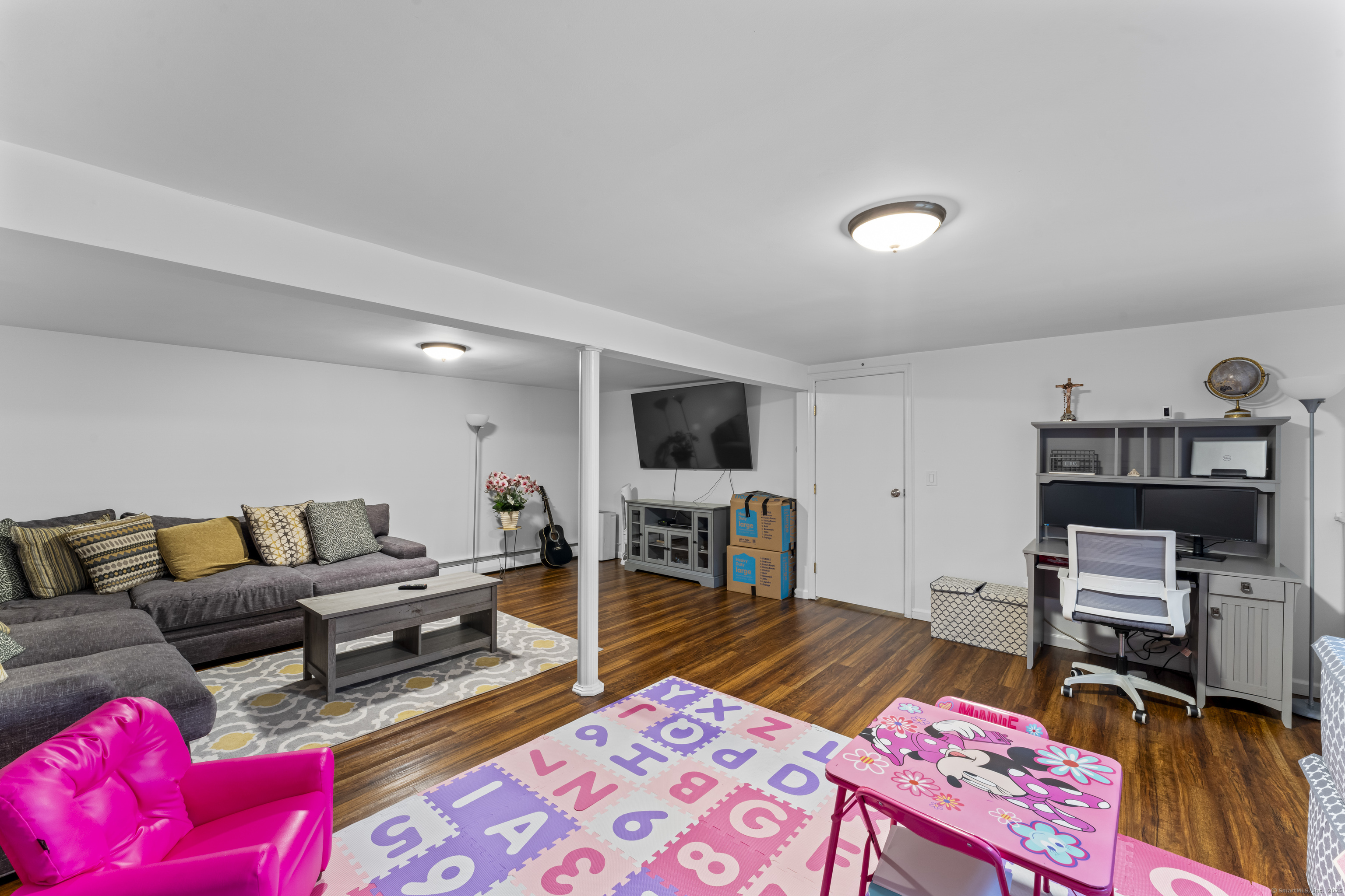 8 Possum Ridge Road Newtown, CT 06470 - Photo 35 of 38 a living room with furniture and a flat screen tv
