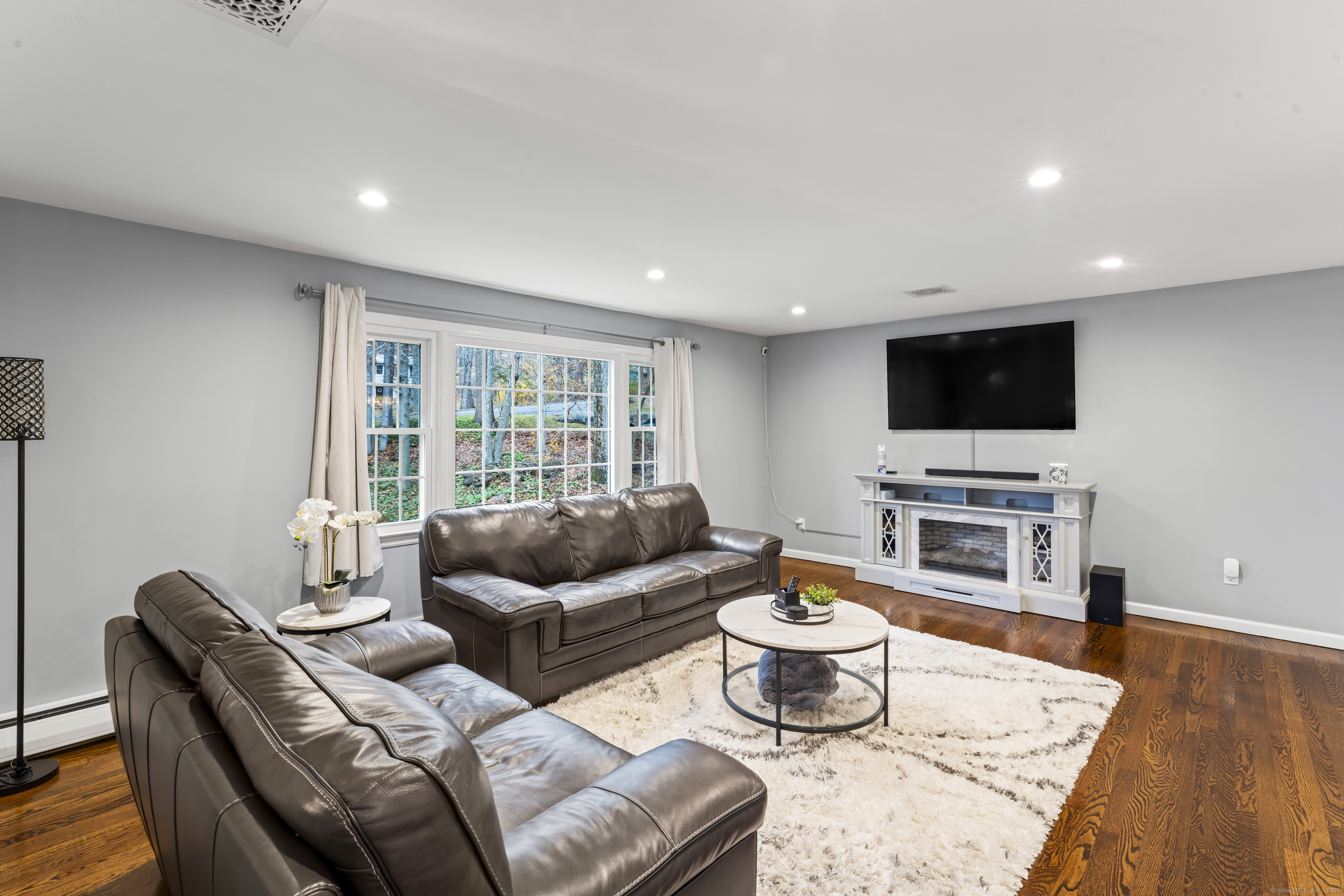 8 Possum Ridge Road Newtown, CT 06470 - Photo 6 of 38 a living room with furniture and a flat screen tv