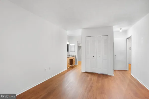 a view of empty room with wooden floor