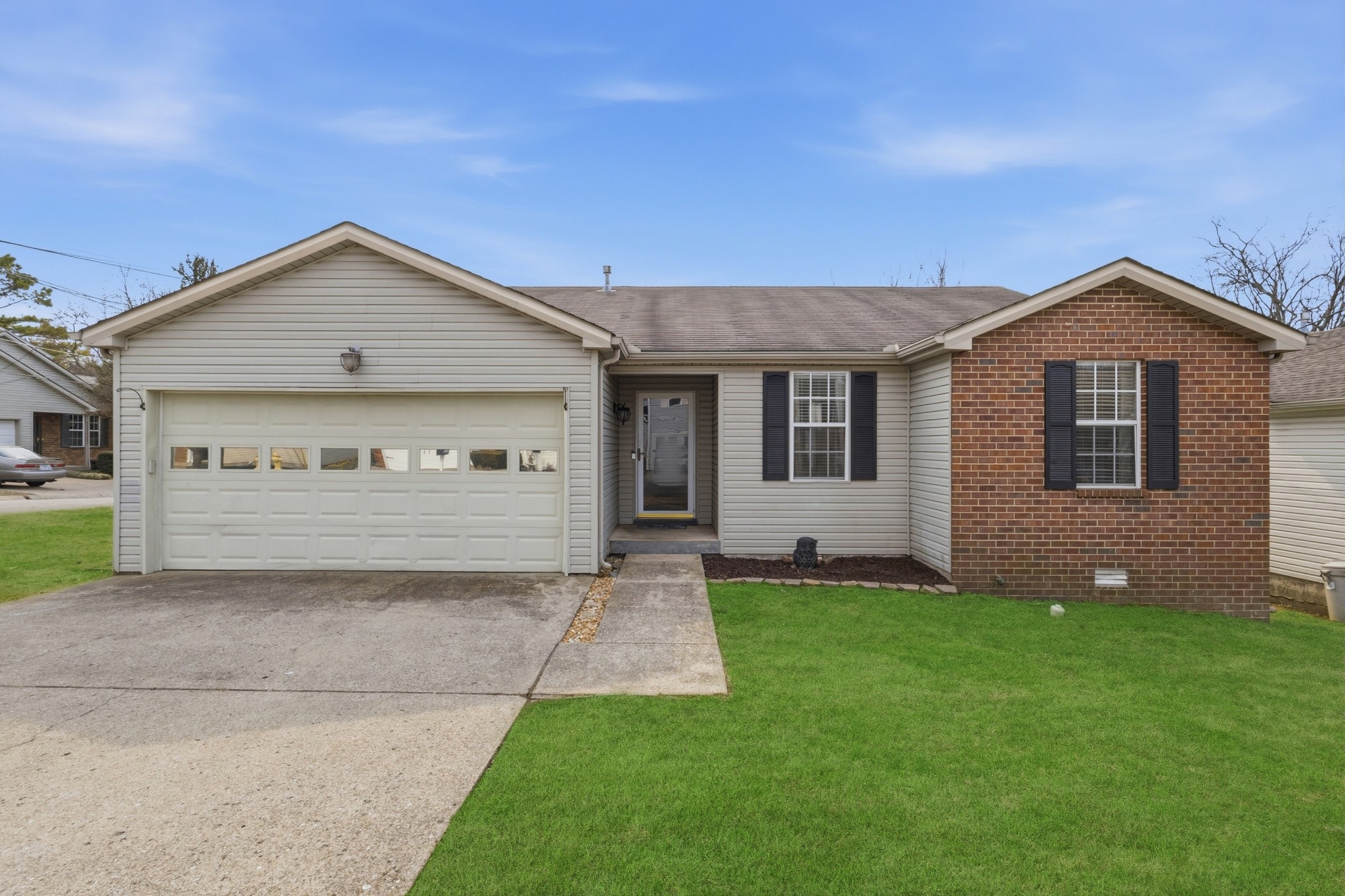 a view of a house with a yard and garage