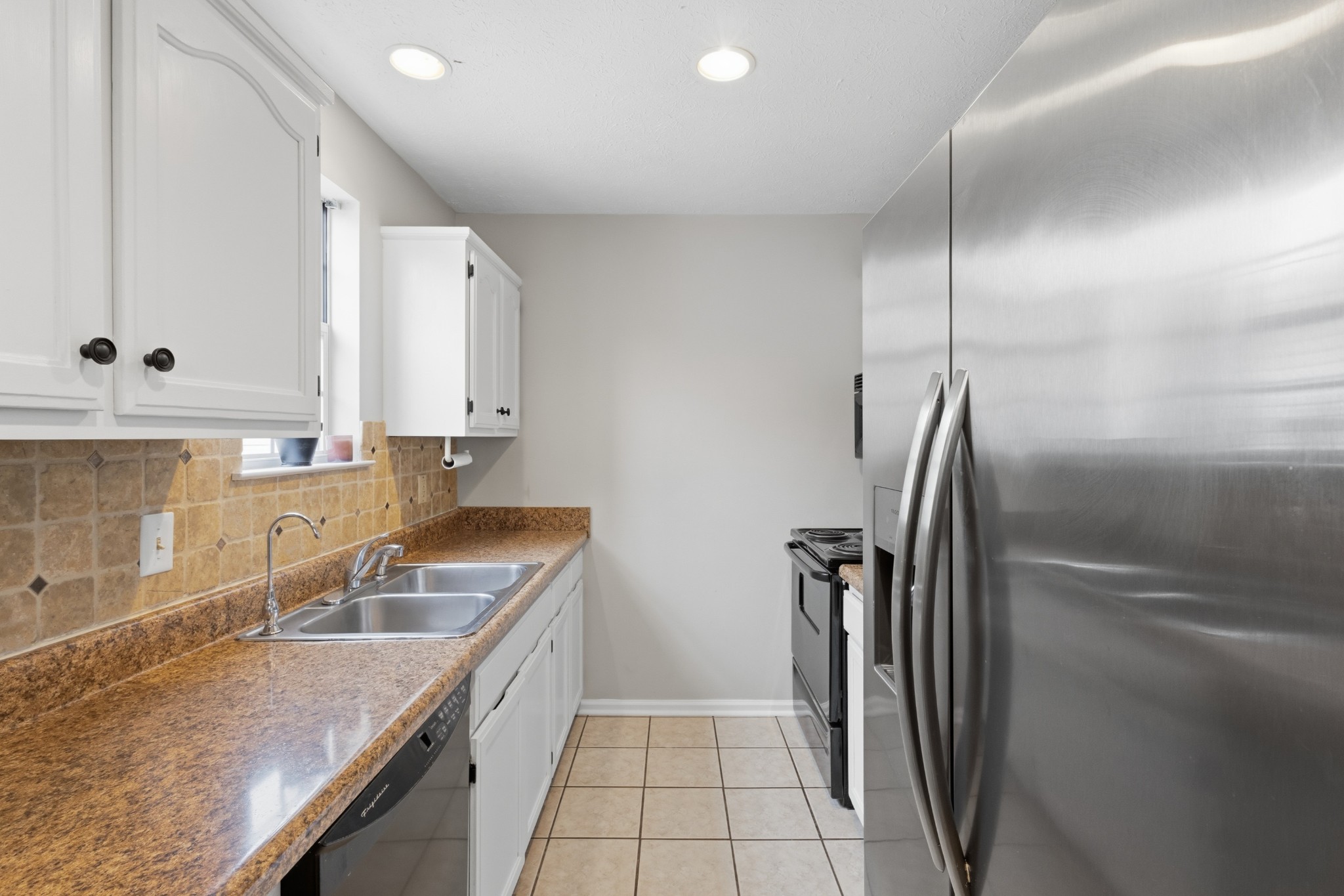 120 River Bend Road Hendersonville, TN 37075 - Photo 14 of 26 a kitchen with a sink a refrigerator and cabinets