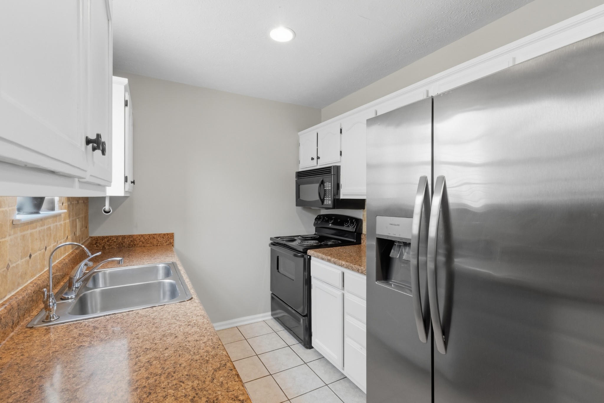 120 River Bend Road Hendersonville, TN 37075 - Photo 15 of 26 a kitchen with stainless steel appliances granite countertop a refrigerator and a sink