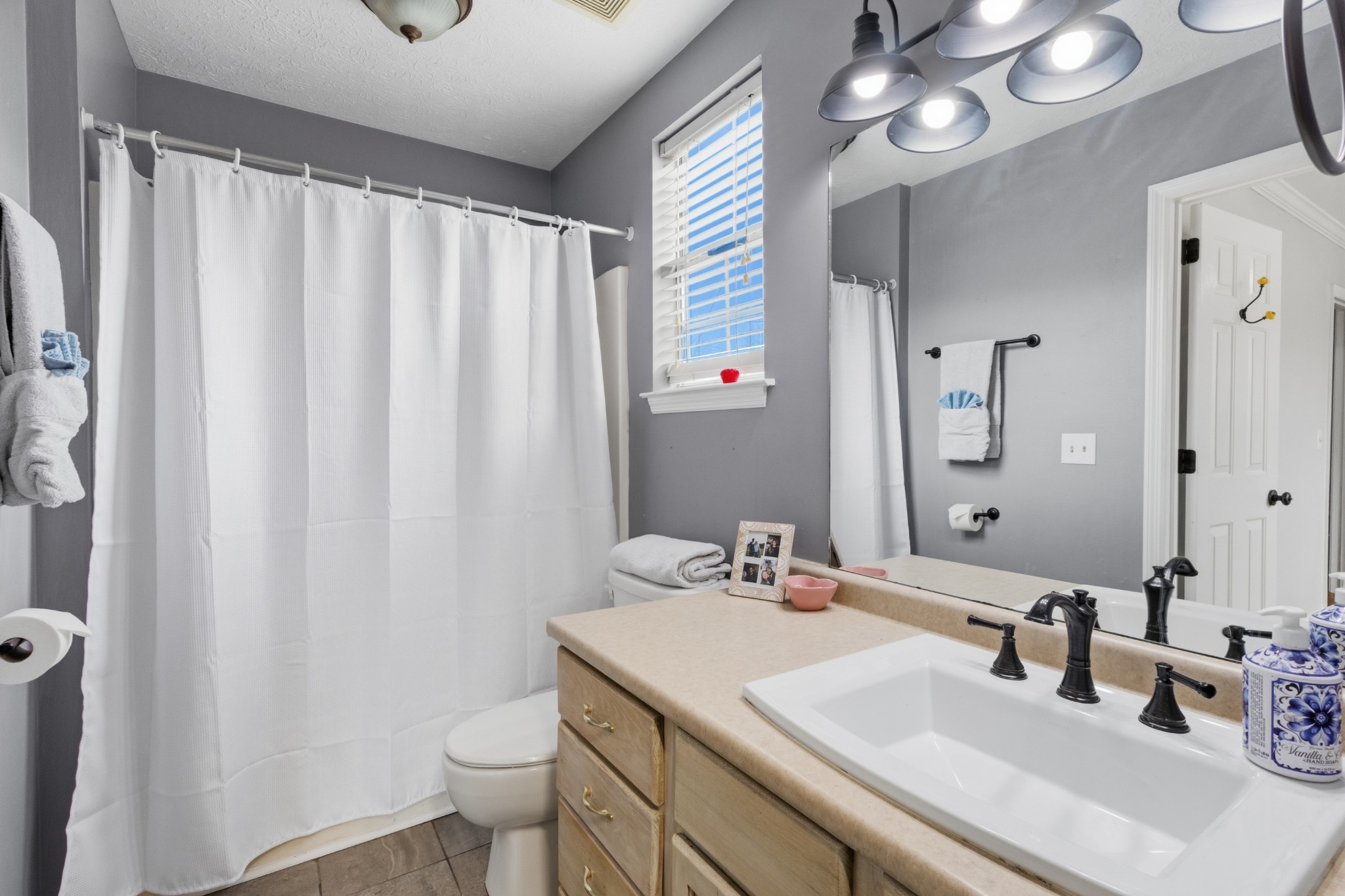 120 River Bend Road Hendersonville, TN 37075 - Photo 9 of 26 a bathroom with a sink a toilet and shower curtain